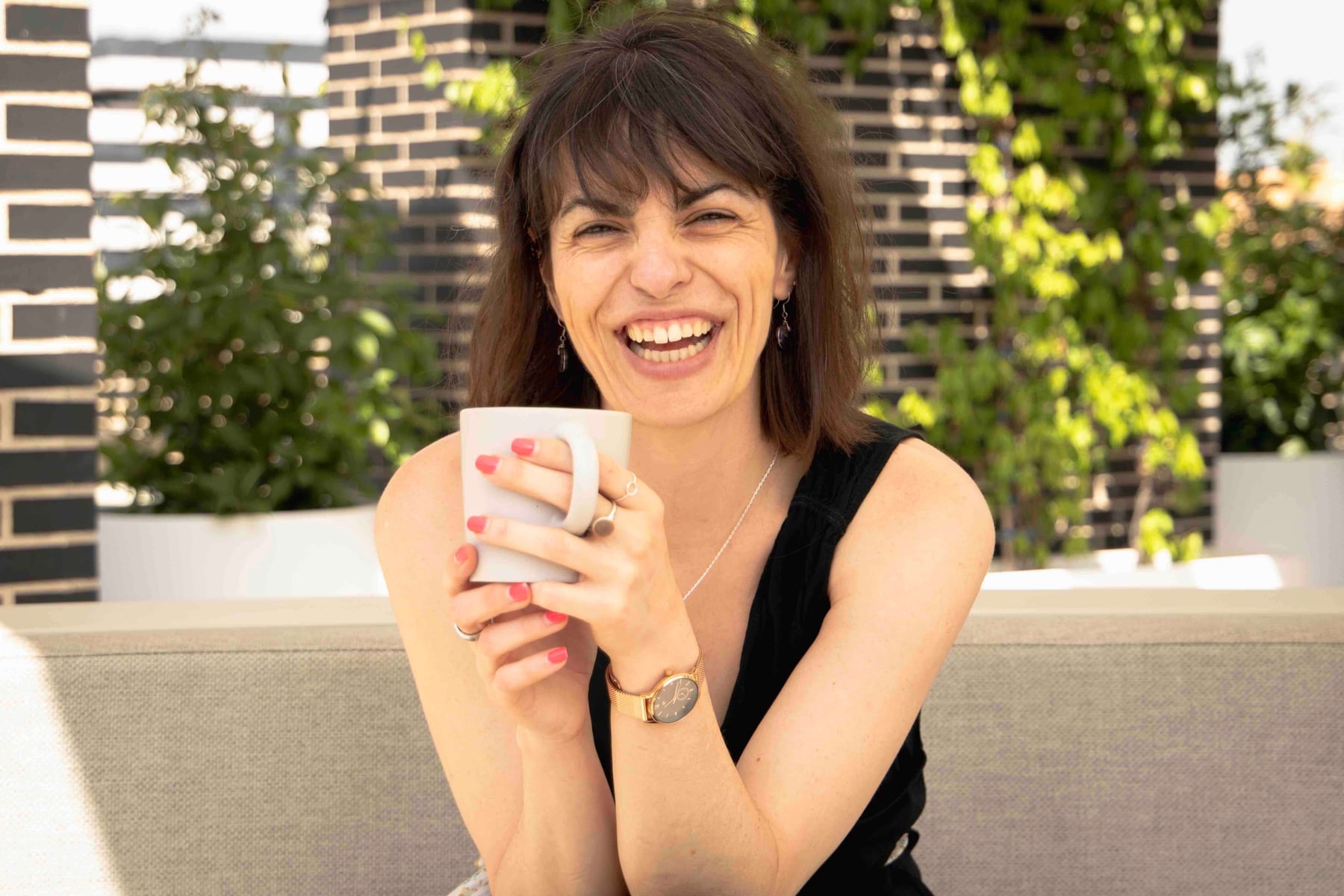 Almu Hernández smiling with a cup